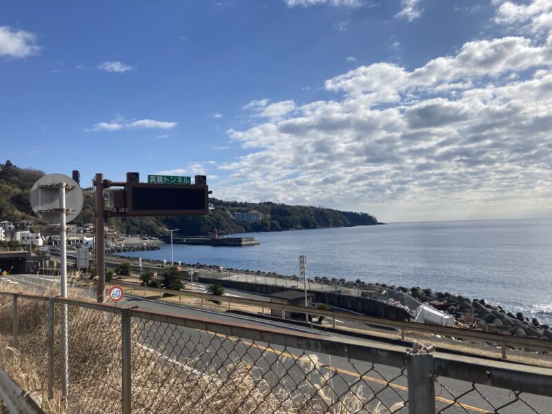 海沿いの道路とトンネル入口の標識