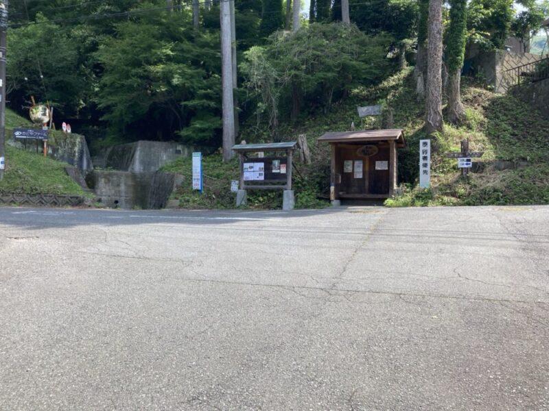 林道を挟んで右側に建物と案内板がある場所