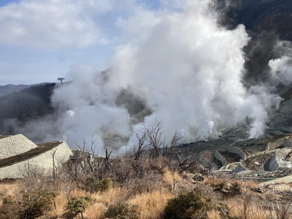 山から白い煙が立ち上る風景